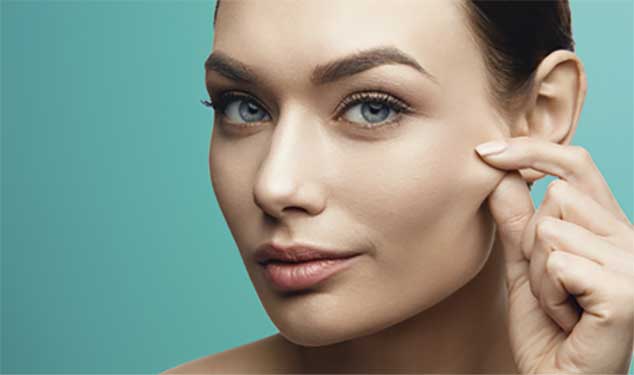 Woman pinching the skin on her cheek for Sofwave ultrasound skin lifting in Dublin